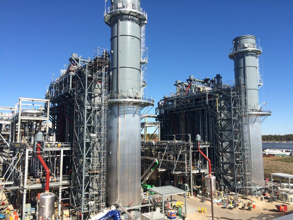 The heat recovery steam generators (HRSG) and pipe rack are seen as construction approached completion.