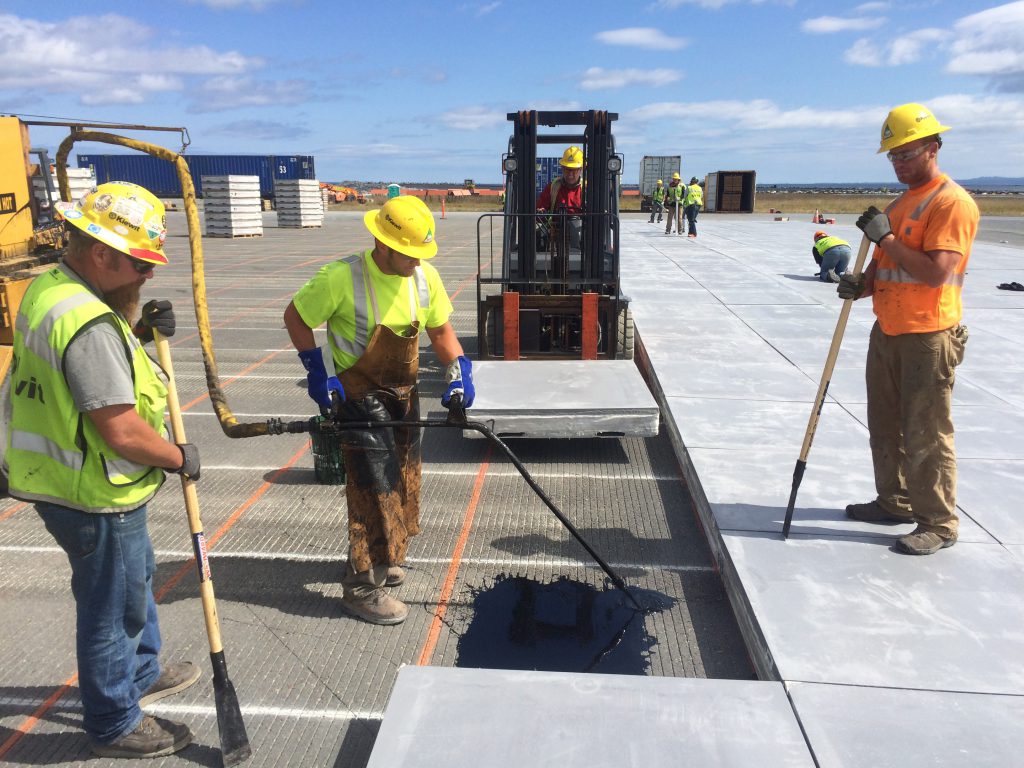 Crews install EMAS blocks at Kodiak Airport. These were the first EMAS bed installations by a Kiewit company.