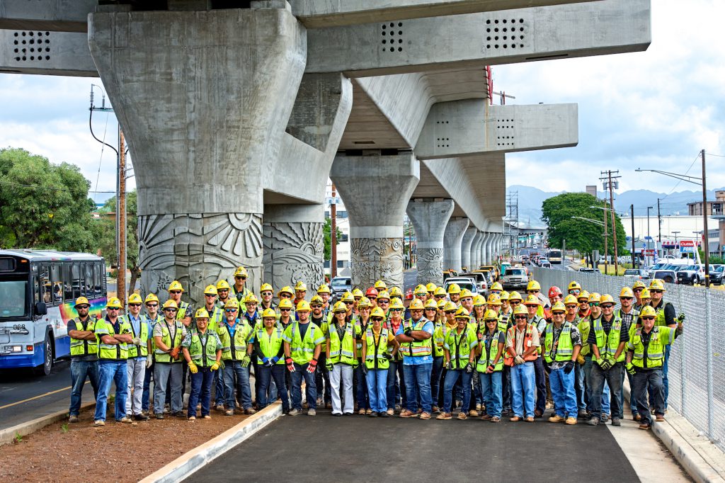 Kiewit staff pose for a picture near the West Loch station work site on Farrington Highway.