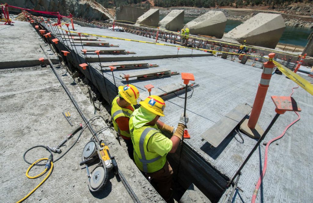 Crews install rebar for the structural concrete walls of the upper chute.