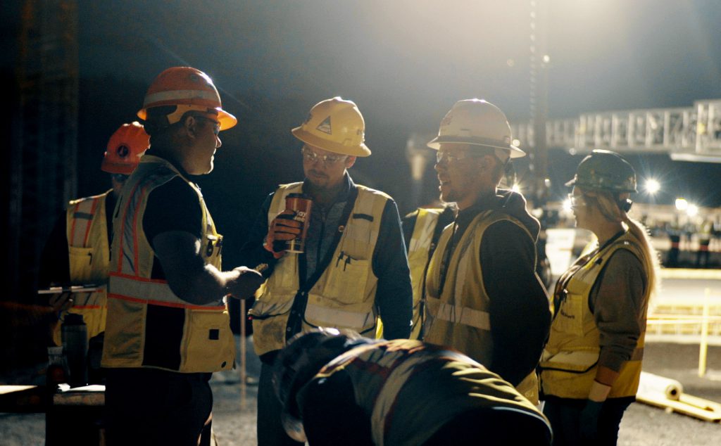 Members of the project team are pictured at a  4:30 a.m. testing and inspection meeting before a  deck pour.