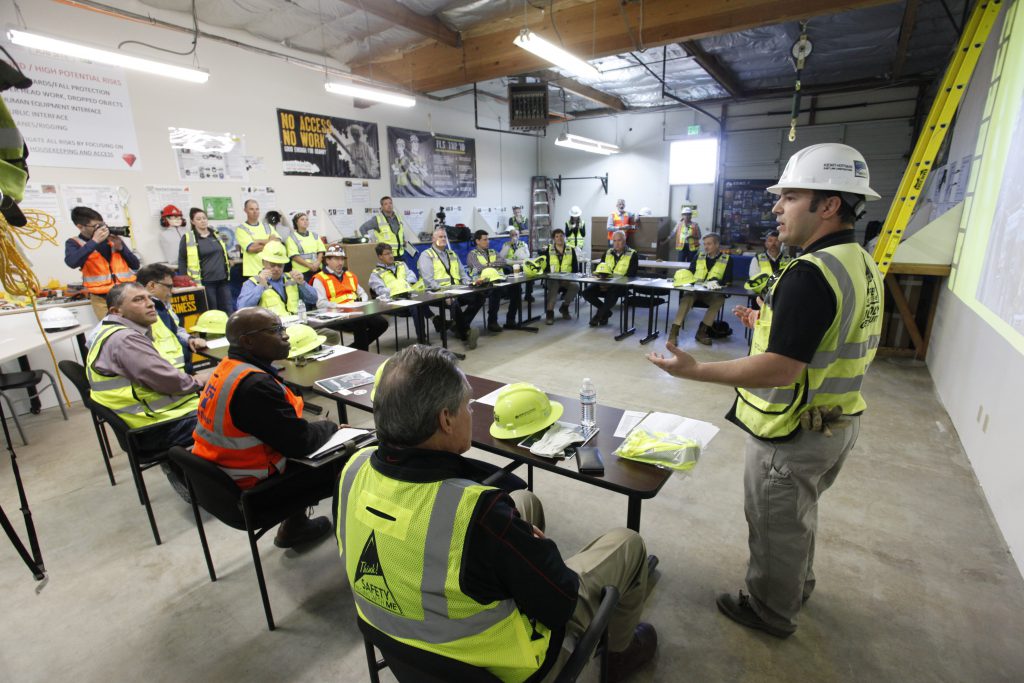 Project staff give a safety orientation to leaders from Sound Transit, Associated General Contractors of America (AGC), Safety Week, Kiewit and Mass Electric Construction Co. They also discussed the craft safety orientation process for the project.