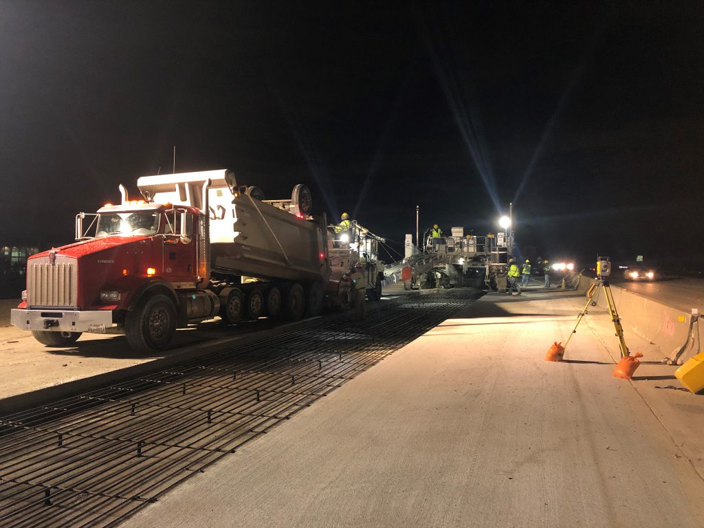 Crews perform 13-inch slip form paving on State Highway 121 using a GNZ600S slip form paver. 