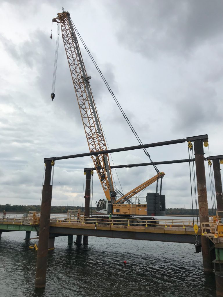 This photo shows the first crossing of a Kiewit LR 1200 SX on the temporary trestle lift span over the Cataraqui River.