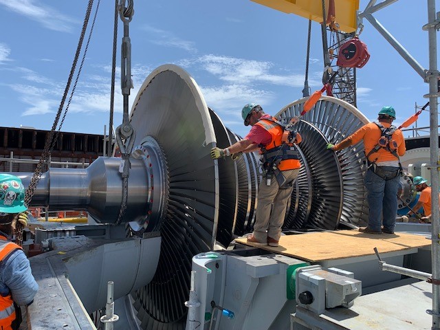 The project team sets in place a turbine guided by a 716-ton crane.