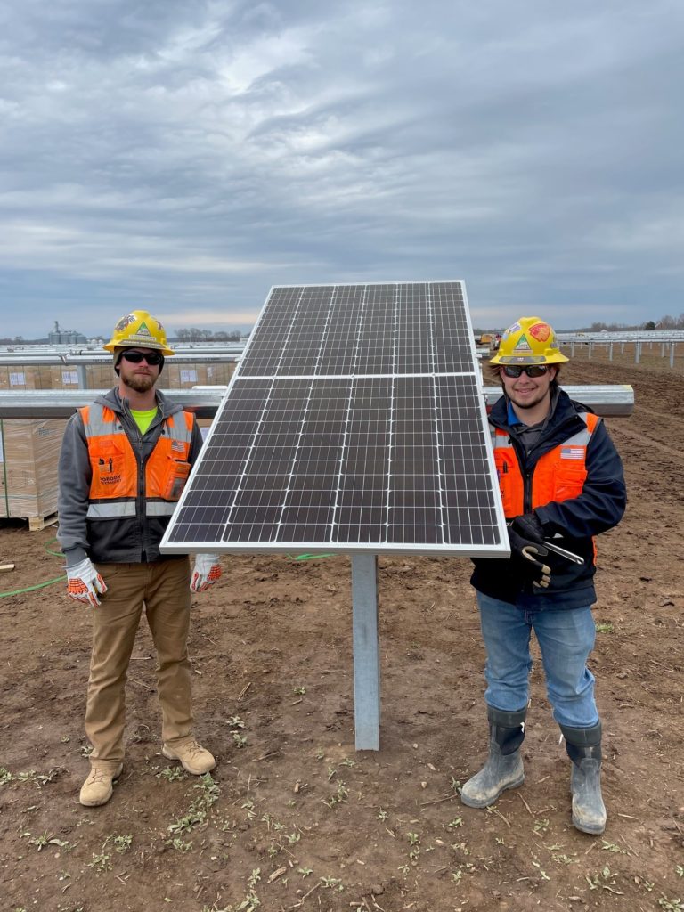 Derrick Morsaw, racking/module superintendent, and Wyatt Franklin, field engineer, help install one of the 776,000 solar panel modules.