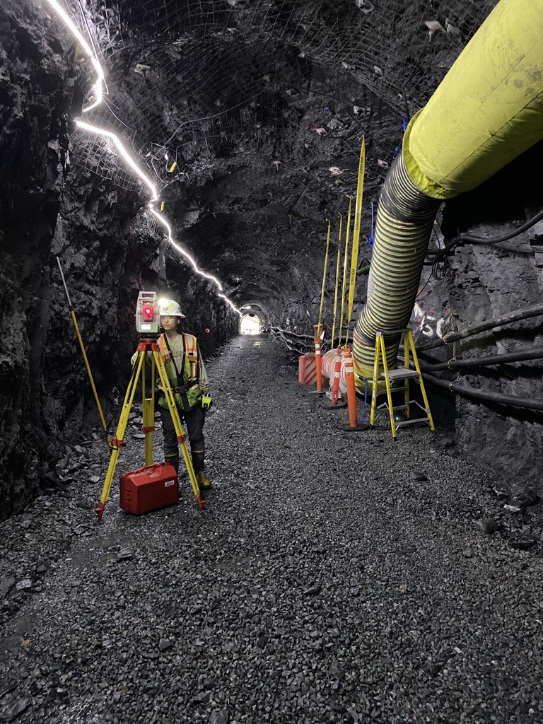 Image of a construction worker using survey equipment in a tunnel