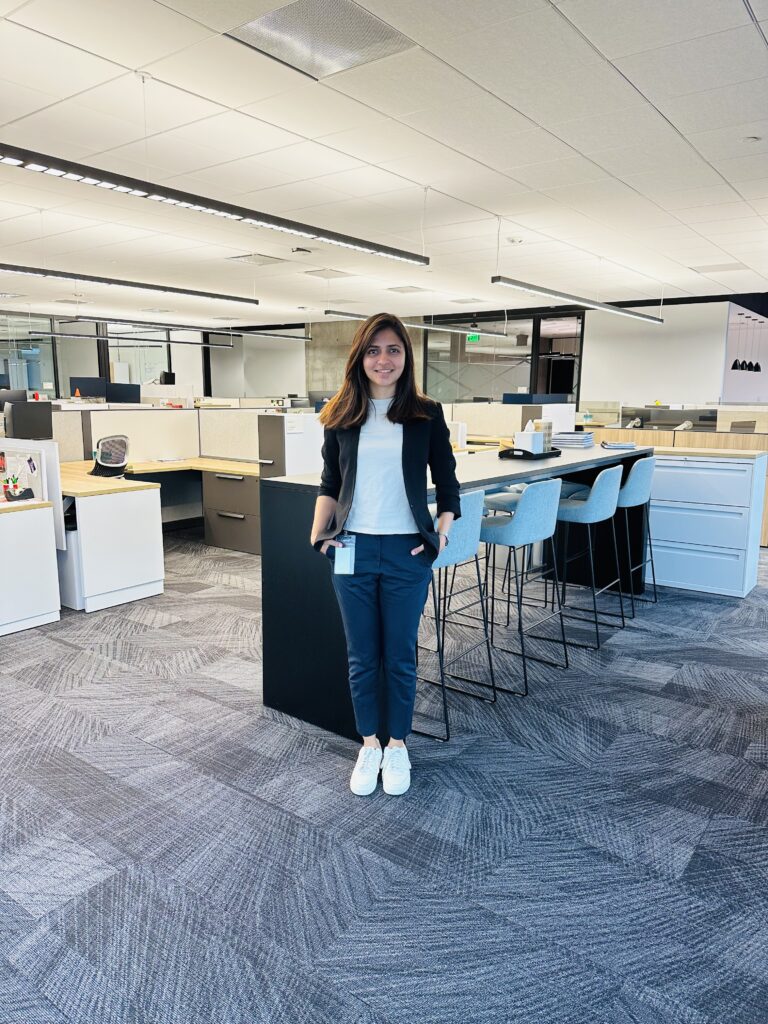 A female in casual business attire posing for a picture in her office