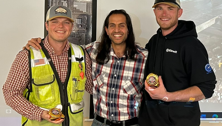 Nasser presents Civil Manager Austin Meadows and Civil Superintendent Garrett Larson with golden tape measure awards for their leadership on the Phase 3 bridge demolition.