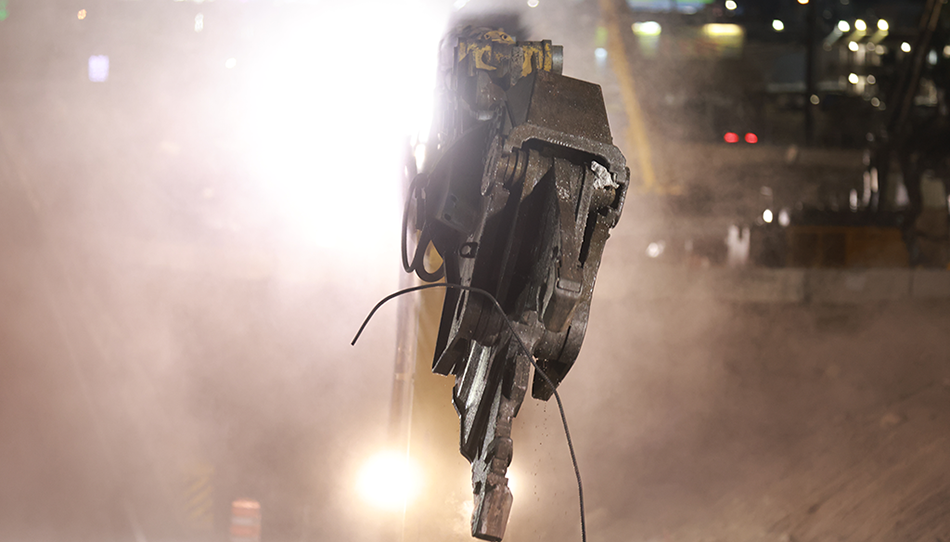 Crews used specialized attachments to demolish the existing bridge. Multiple excavators equipped with processors helped crush, cut and pulverize the previous concrete.