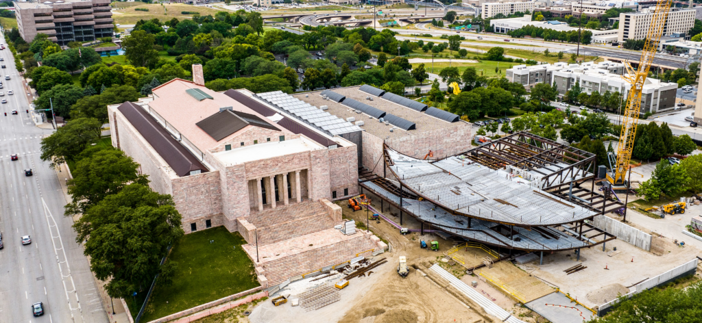 The new Rhonda and Howard Hawks Pavilion, shown under construction in this photo, required a complex steel structure, including large cantilevers that extend 40 feet out and above the main level of the building. Its curves are in stark contrast to the original rectangular museum buildings.