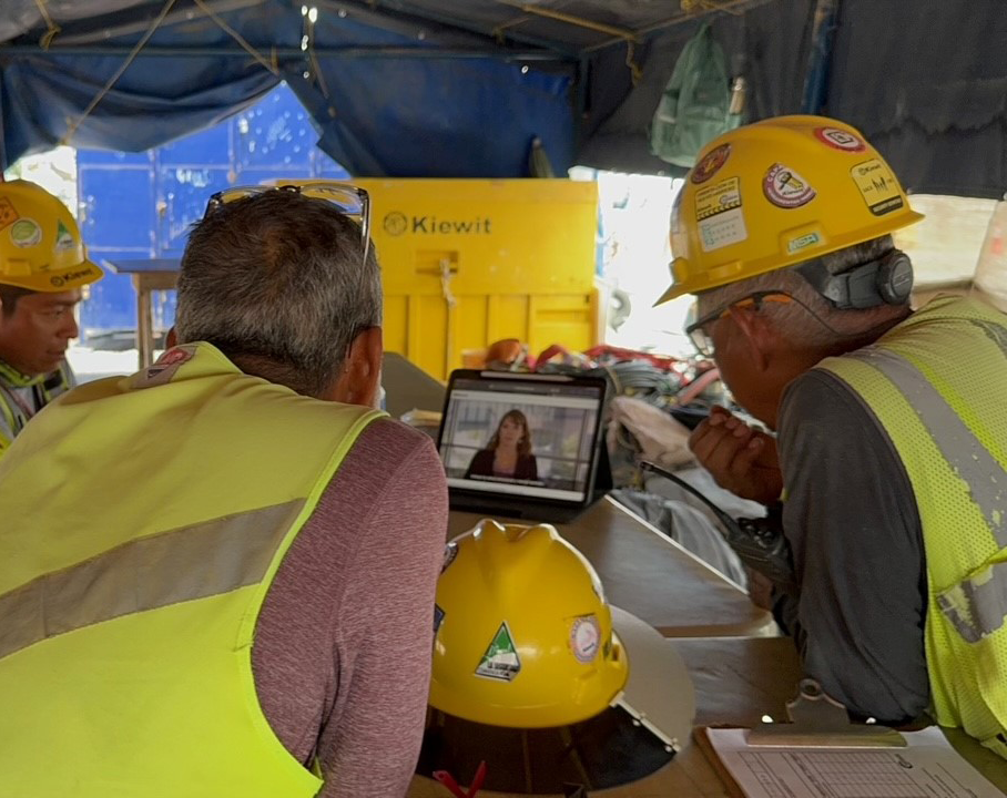 Employees in Mexico gather around monitors to watch Senior Vice President Alicia Edsen’s translated message during Construction Suicide Prevention Week.