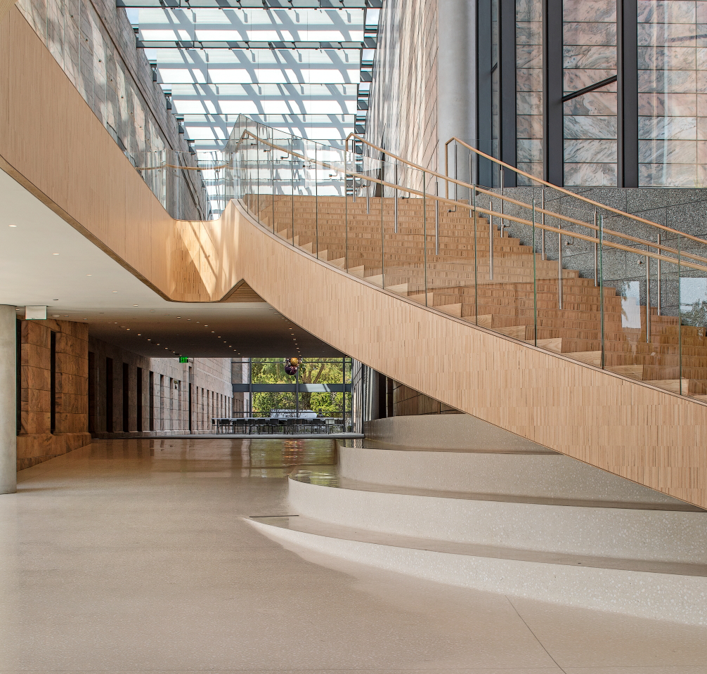 A winding staircase leads museum visitors from the entry atrium to new galleries on the second floor. The staircase and entire second floor are suspended from above.