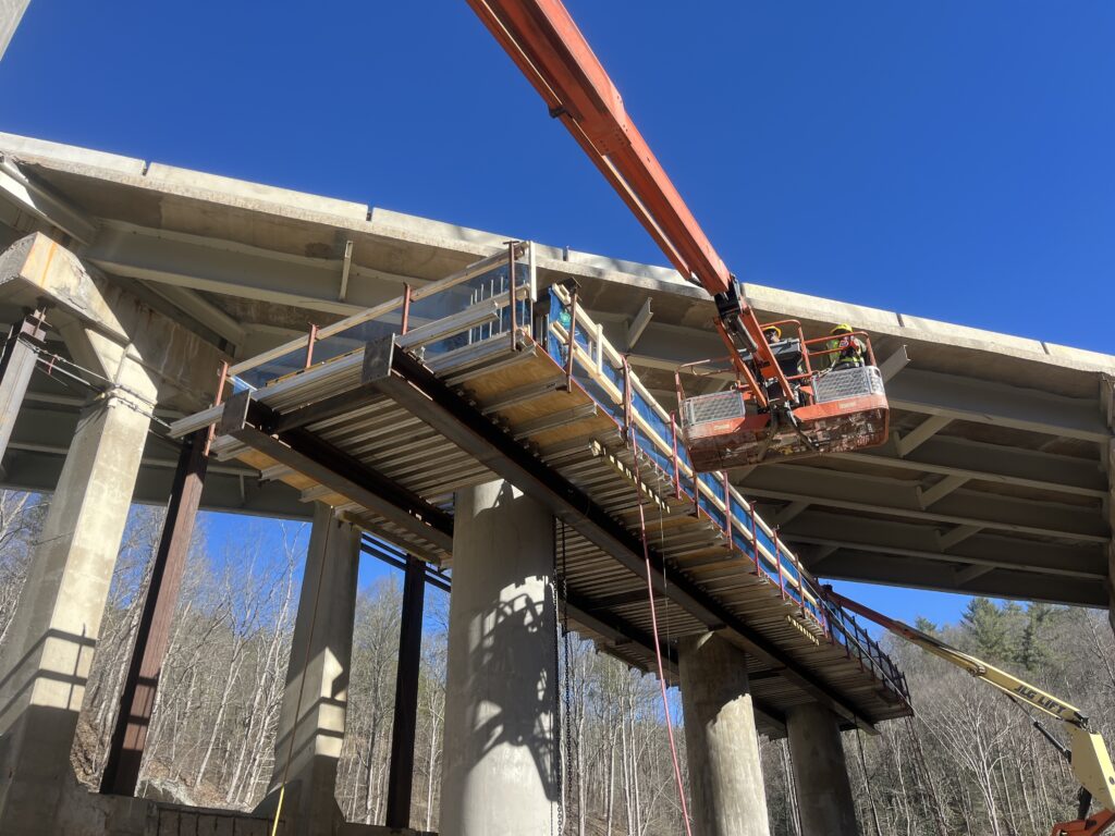 Kiewit employees erect a soffit for one of the new caps on the substructure of Bridge 142 over the Pigeon River. The three-span bridge is about 50 feet tall, 364 feet long and 81 feet wide. The substructure is designed to hold 63-inch Florida I-beams that weigh up to 71 tons.