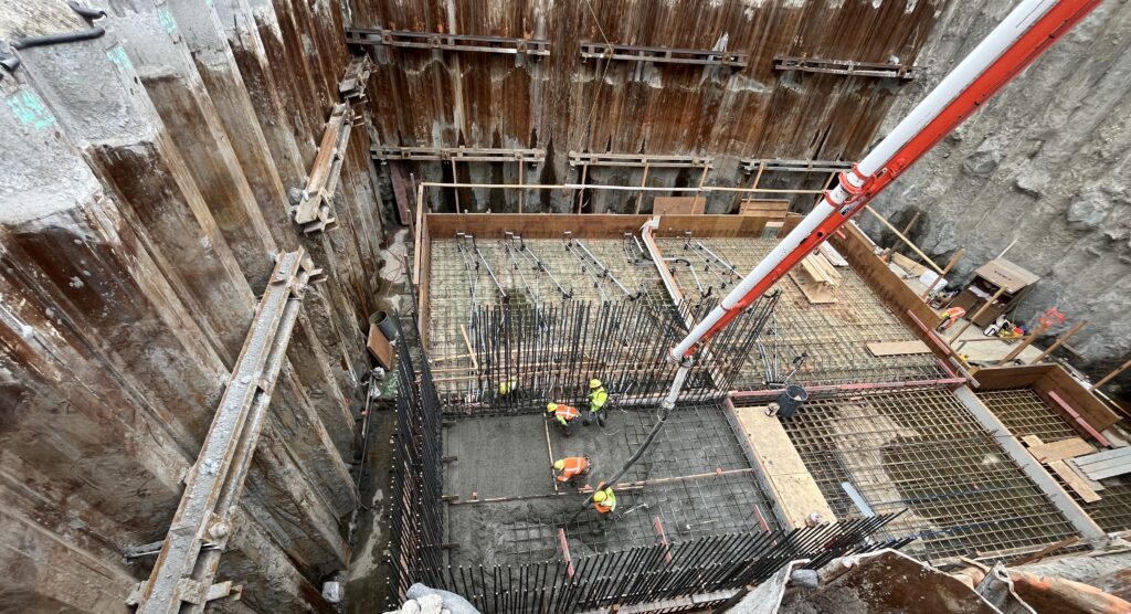 The first step in constructing the pump station buildings involved preparing the foundation. Here, the pour crew places concrete for one section of the Ballona Creek building. The foundation was covered with a vapor barrier and reinforced with rebar and concrete forms, ensuring long-term stability, preventing groundwater seepage and maintaining building integrity. 